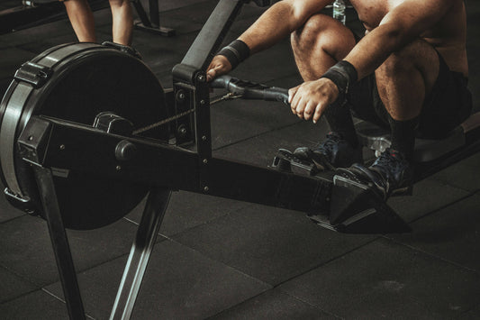 Person doing a vigorous workout on a Wenoker magnetic rowing machine at home, demonstrating proper form for maximum calorie burn.