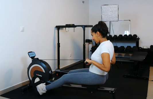 Person enjoying a low-impact, full-body workout on the Wenoker Rowing Machine at home.