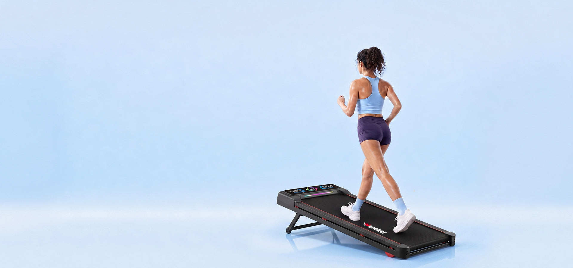 Woman riding a Wenoker exercise bike in a calm home living room