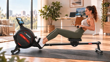 A remote professional taking a 15-minute lunchtime rowing break on the Wenoker R10 magnetic rower in a tidy home office.