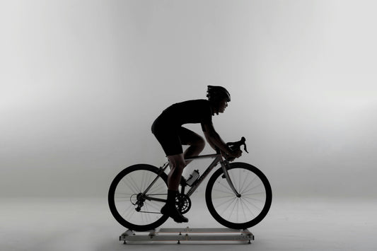 A person engaging in an indoor cycling workout on a Wenoker exercise bike in a modern home setting.